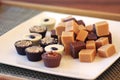 Chocolate fudge and bonbons on a white plate