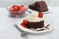 Chocolate Fudge Brownie topped with whipped cream and strawberries Royalty Free Stock Photo