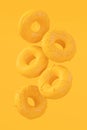 Chocolate glazed donut with sprinkles on plain monochrome yellow color Royalty Free Stock Photo
