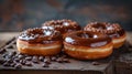 Chocolate glazed donuts with sprinkles surrounded by coffee beans Royalty Free Stock Photo