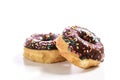 Chocolate glazed donuts with sprinkles on a white background