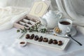 Chocolate handmade candies and cup of tea on the table Royalty Free Stock Photo