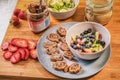 Chocolate hazelnut spread or Nutella cream crepe rolls with fresh fruits like strawberries and blueberries on rustic wooden board Royalty Free Stock Photo