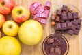Chocolate with hazelnuts, a meter and fruits, apples, bananas, greyfruit. Chocolate or fruit diet.