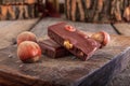 Chocolate with hazelnuts on wooden board Royalty Free Stock Photo