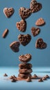 Chocolate heart cookies in motion against calming blue background