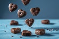 Chocolate heart cookies in motion against calming blue background