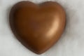 Chocolate heart resting on soft wadding