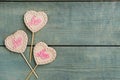 Chocolate heart shaped lollipops with word Love on light blue wooden table, flat lay. Space for text Royalty Free Stock Photo