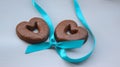 Chocolate heart sweets and bright ribbon.