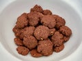 Chocolate homemade cookies with nuts, on a pile in a large white bowl Royalty Free Stock Photo