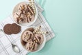 Chocolate homemade ice cream decorated with nuts, chocolate chips, wafer rolls, in white bowl. Summer cooling desserts Royalty Free Stock Photo