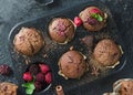 Chocolate homemade muffins with rapsberry on black background