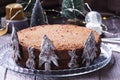 Chocolate honey cake in a Christmas decoration on a wooden background. Royalty Free Stock Photo