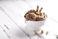 Chocolate ice cream balls with pistachio and cookies in a white bowl Royalty Free Stock Photo