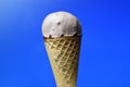 Chocolate ice cream cone on blue background Royalty Free Stock Photo