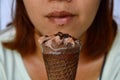 Chocolate ice cream in front of woman stain lip