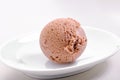 Chocolate ice cream scoop on white plate close-up Royalty Free Stock Photo