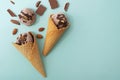 Chocolate ice cream in a waffle cone, blue background, flat lay, top view, copy space. Summer cooling desserts