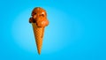Chocolate Ice Cream in a Waffle Cone Isolated on a Blue Background Royalty Free Stock Photo
