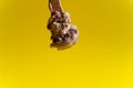 Chocolate ice cream on wooden spoon on yellow background Royalty Free Stock Photo