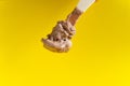 Chocolate ice cream on wooden spoon on yellow background Royalty Free Stock Photo