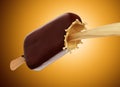 Chocolate icecream with wooden stick and milk splash