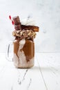 Chocolate indulgent exreme milkshake with brownie cake, marshmallow and sweets. Crazy freakshake food trend. Royalty Free Stock Photo