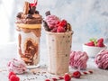 Chocolate indulgent frosting exreme milkshake with donut and sweets. Crazy freakshake food trend. Copy space