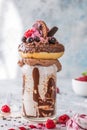 Chocolate indulgent frosting exreme milkshake with donut and sweets. Crazy freakshake food trend. Copy space