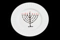 Chocolate and jam hanukkiah on a white plate and black background