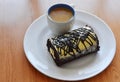 Chocolate jam roll filled cream eat couple with coffee on plate