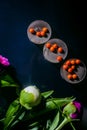 Chocolate kontsety, with peonies, on a dark mirror background