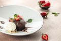 chocolate lava cake with fresh strawberries, ice-cream ball and mint, Food recipe background. Close up Royalty Free Stock Photo