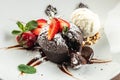 chocolate lava cake with fresh strawberries, ice-cream ball and mint, Food recipe background. Close up Royalty Free Stock Photo