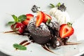 chocolate lava cake with fresh strawberries, ice-cream ball and mint, Food recipe background. Close up Royalty Free Stock Photo