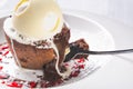 Chocolate lava cake Molten with melting ice cream, chocolate with spoon on plate and white background