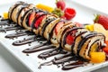 Chocolate Maki Sushi Pancake Rolls Stuffed with Fruits and Cheese Close Up, Sliced Pancake Royalty Free Stock Photo