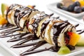 Chocolate Maki Sushi Pancake Rolls Stuffed with Fruits and Cheese Close Up, Sliced Pancake Royalty Free Stock Photo