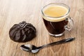 Chocolate marshmallow, coffee in transparent cup, spoon on wooden table Royalty Free Stock Photo