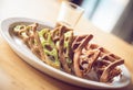 Chocolate and matcha waffle on white plate with glass of caramel