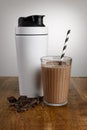 Chocolate milkshake, ingredients  and shaker with paper straw on a wooden bench top Royalty Free Stock Photo