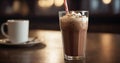 Chocolate milkshake with whipped cream in a tall glass with a straw on a dark background