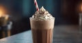 Chocolate milkshake with whipped cream in a tall glass with a straw on a dark background