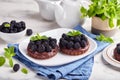 Chocolate mini cakes with chocolate cream and blackberries