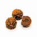 Chocolate mini petit fours with liquid caramel-orange filling isolated on white background Royalty Free Stock Photo