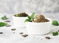 Chocolate mint ice cream in white bowls with pieces of chocolate and mint leaves on a marble table Royalty Free Stock Photo