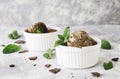 Chocolate mint ice cream in white bowls with pieces of chocolate and mint leaves on a marble table Royalty Free Stock Photo