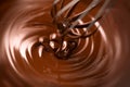 Chocolate. Mixing melted dark chocolate with a whisk. Closeup of liquid hot chocolate swirl Royalty Free Stock Photo