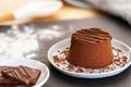 Chocolate Moelleux cake or molten cake in a grey plate with grated chocolate, spilled flour and chocolate pieces on a slate Royalty Free Stock Photo